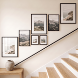 The balanced seven-frame set seen at an angle above an oak console