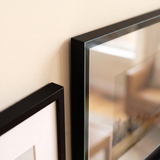 Close detail of the glazing pane, slim black moulding and white mat