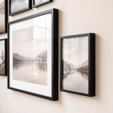 Close detail of the matted 16x20 beside an unmatted Signature frame, both glazed