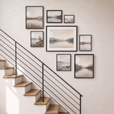 Compact eight-frame black stair-step gallery wall, one matted 16x20 with seven unmatted glazed frames