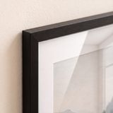 Close detail of the brushed aluminium profile, glazing pane edge and 11x17 white mat