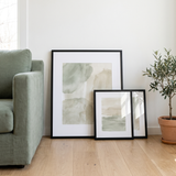 Three frames from the set leaning against the wall before hanging — one 16x20 and two 8x10 
