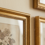 Close-up of the antique gold beaded molding, mitered corner and glass 