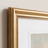Close-up of the antique gold fine beaded molding, mitered corner and bevelled mat edge 