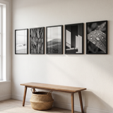 The five-frame row along an entry hallway above a bench 