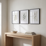 The three-frame Streamline set above an oak console in an entry hall 