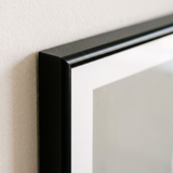 Close-up of the slim black moulding, mitred corner and bevelled white mat 