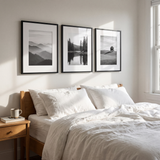 The set hung above a bed with white linen bedding 