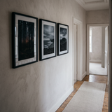 The three-frame poster row along a hallway wall 