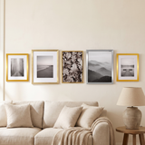 The row above a linen sofa in a warm living room 