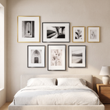 The gold and black set above a bed with white linen bedding 