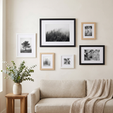 The six-frame set arranged above a linen sofa in a living room 