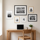The six-frame set above an oak desk in a home office 