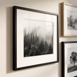 Angled view showing the slim frame profile, mat bevel and depth against the wall 