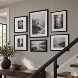 Mixed-Size Stairway Gallery — Black · 6 Frames — styled on a grey stair wall