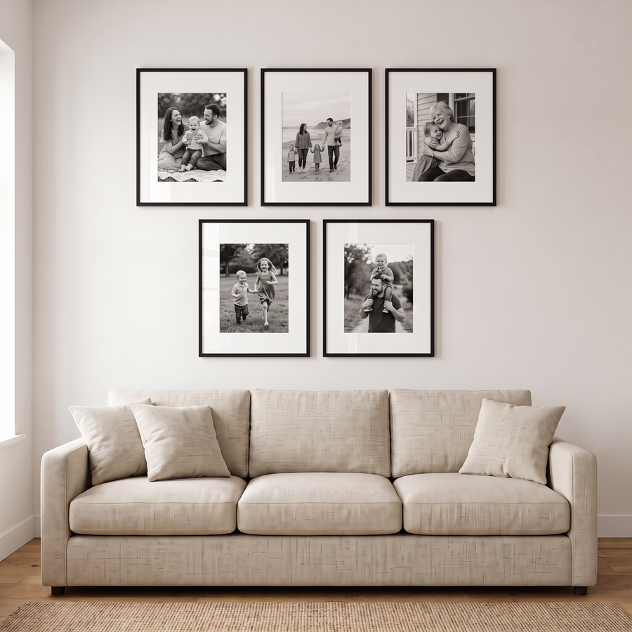 Galleria Statement Five: five black Galleria 16x20 frames, matted to 11x14, hung three over two. Shown in a living room, above a long low oatmeal linen sofa, with family photos in the frames 