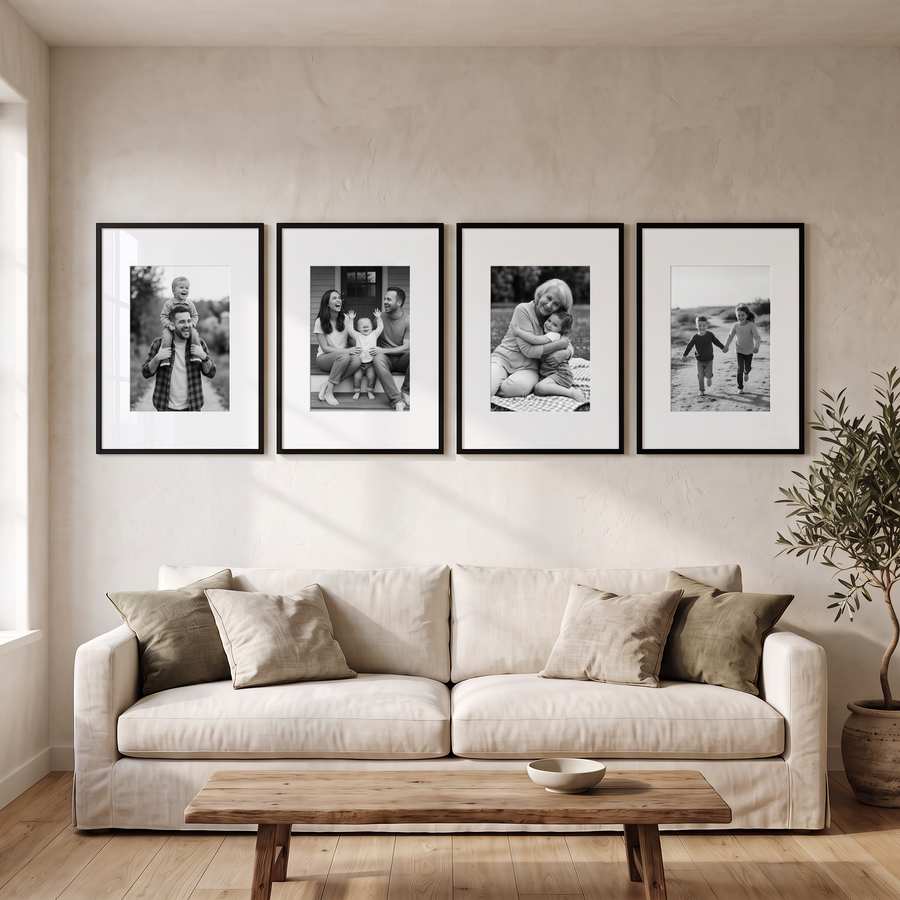 Wide Mat Quad 22x28 — Black · 4 Frames — styled in a row above a sofa, with family photos in the frames 