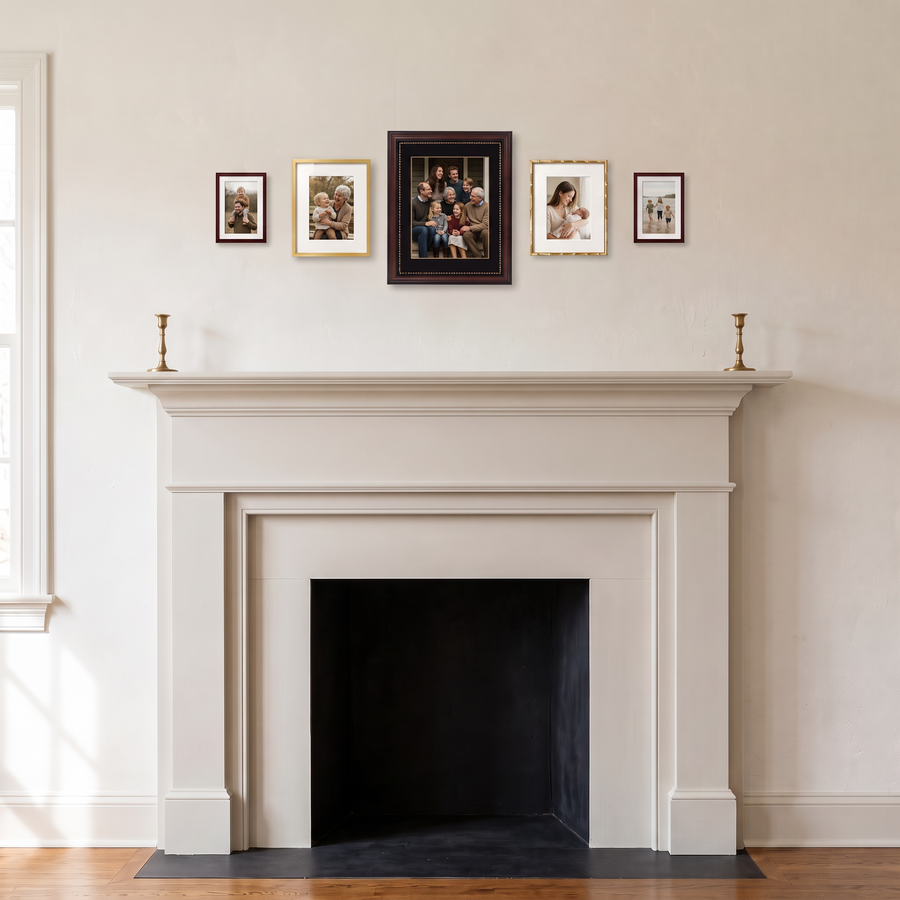 Petite Heirloom Five: five matted frames in mahogany and gold, stepping up to a mahogany 11x14 at the centre. Shown in a traditional living room, above a white fireplace mantel, with family photos in the frames 
