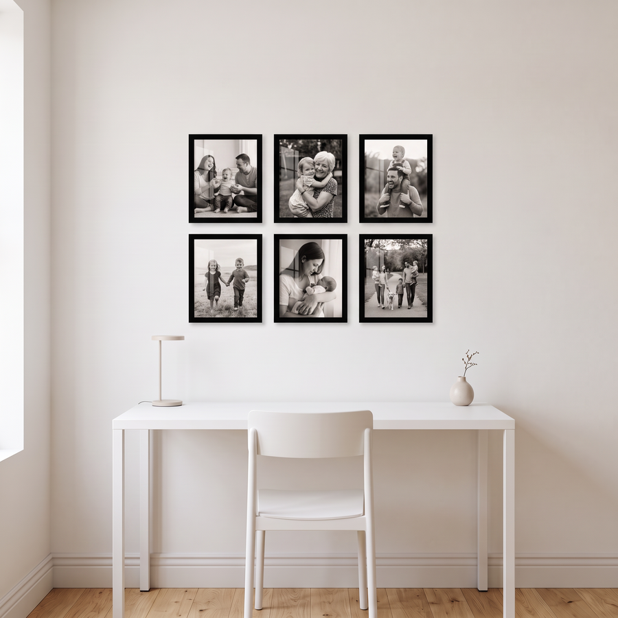Signature Grid Six: six identical unmatted black Signature 8x10 frames in a three-by-two grid. Shown in a home office nook, above a small white desk with a chair, with family photos in the frames 