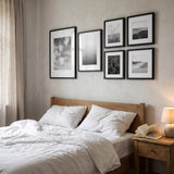 The six-frame set hung above a bed with linen bedding 