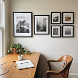 The six-frame set above a wooden desk in a home office 