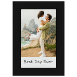 Black Instax frame holding an instant photo of a couple on a clifftop, captioned Best Day Ever 