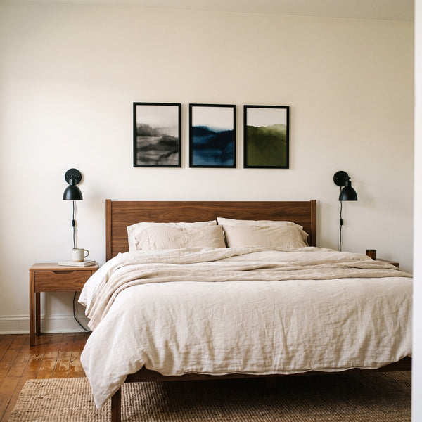 Three black 12x17 unmatted poster frames in a row above a walnut queen headboard, true to size #flat