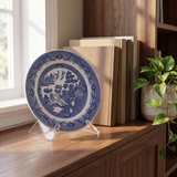 6-inch clear acrylic display stand holding a blue and white porcelain plate on a walnut bookshelf 
