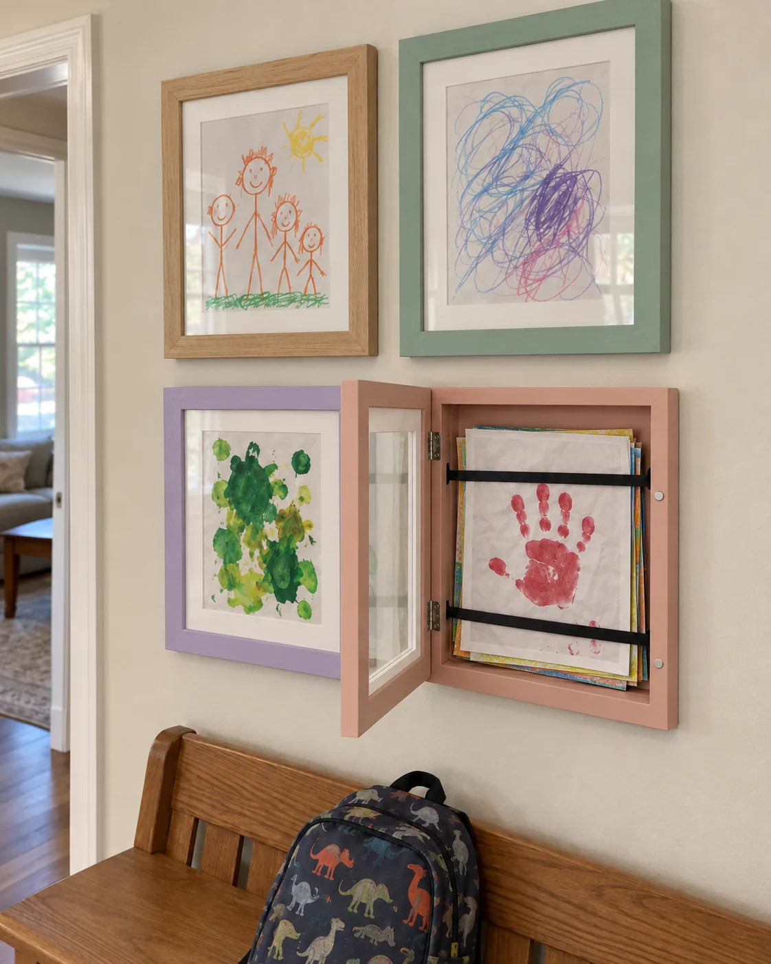 Light wood, seafoam, lilac and peach artwork frames, with one frame open to show stored drawings